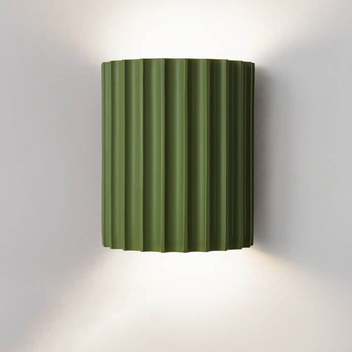 Green wall-mounted lamp with ribbed design on a white background