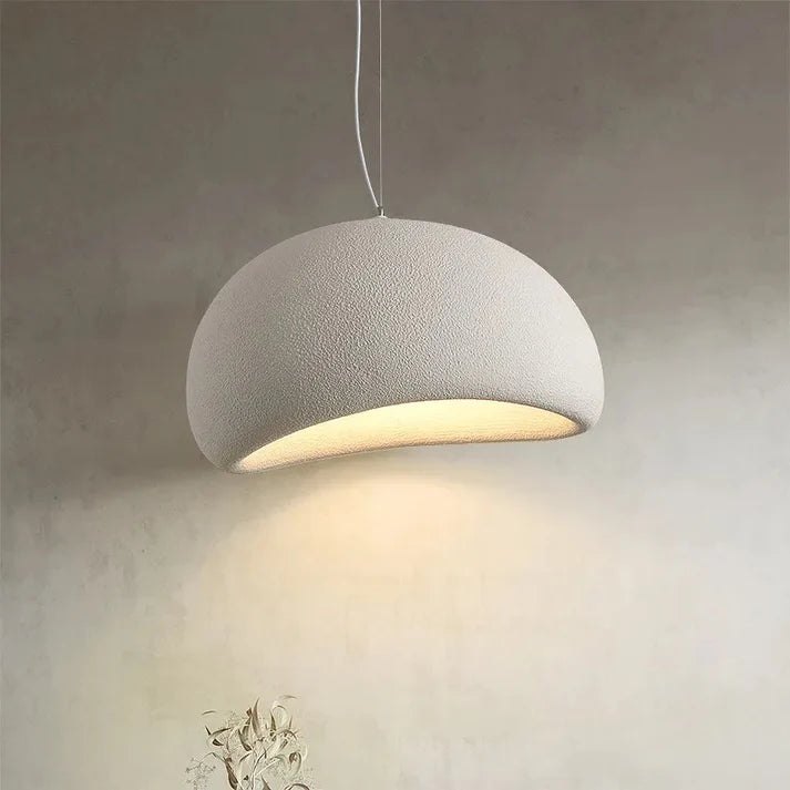 Concrete pendant light fixture on a neutral background