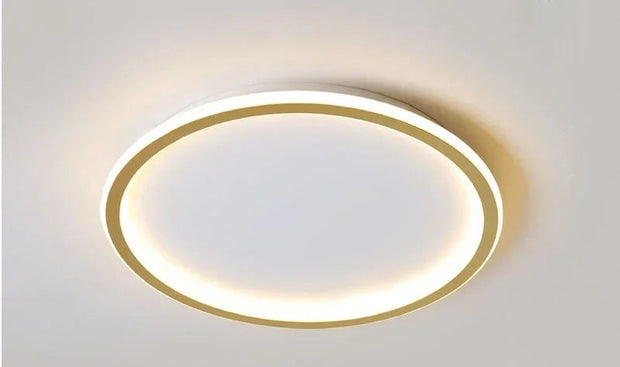 Gold round ceiling light fixture on a white wall with dimensions and specifications displayed.