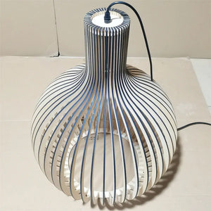 Modern lamp with striped design on a white surface