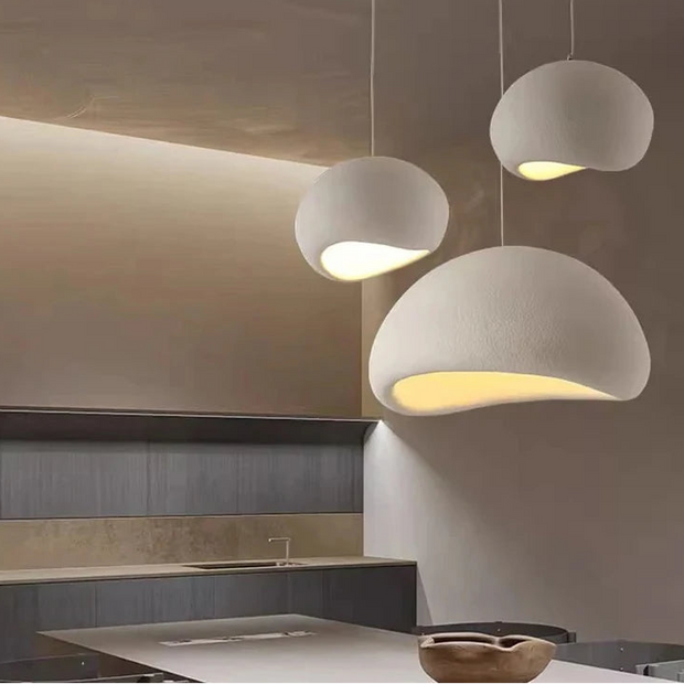 Modern kitchen with concrete pendant lights and JAYMP branding.