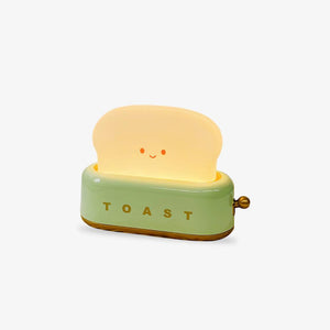 Toy toaster with a smiling piece of bread on a white background