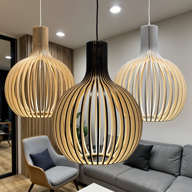 Three pendant lights hanging above a living room with a sofa and chair.