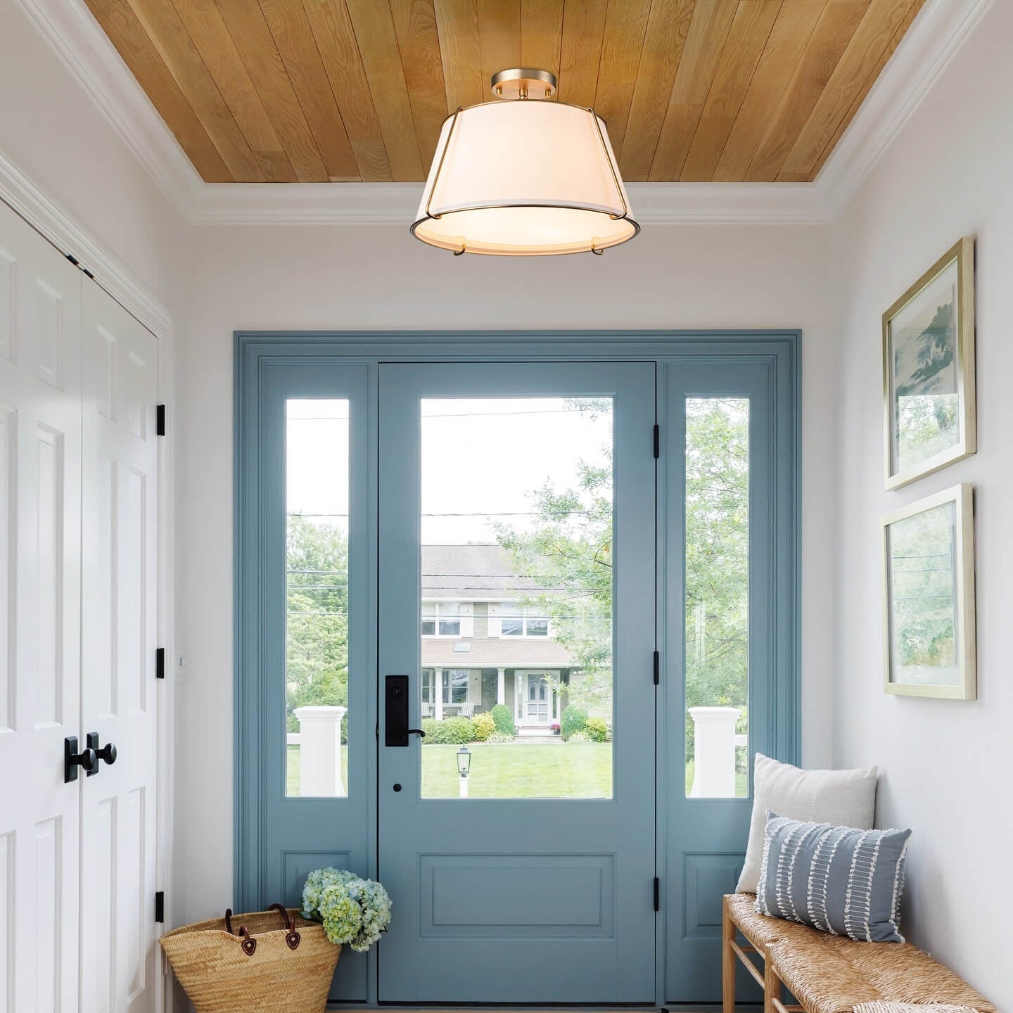 Foyer with blue door, light fixture, and decorative elements