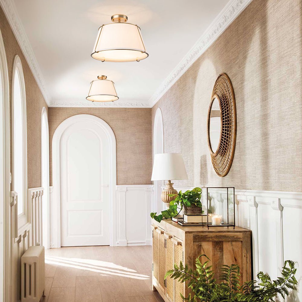 Elegant hallway with wooden console table, decorative mirror, and plants.