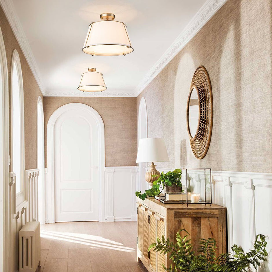 Elegant hallway with wooden console table, decorative mirror, and plants.