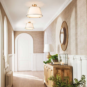 Elegant hallway with wooden console table, decorative mirror, and plants.