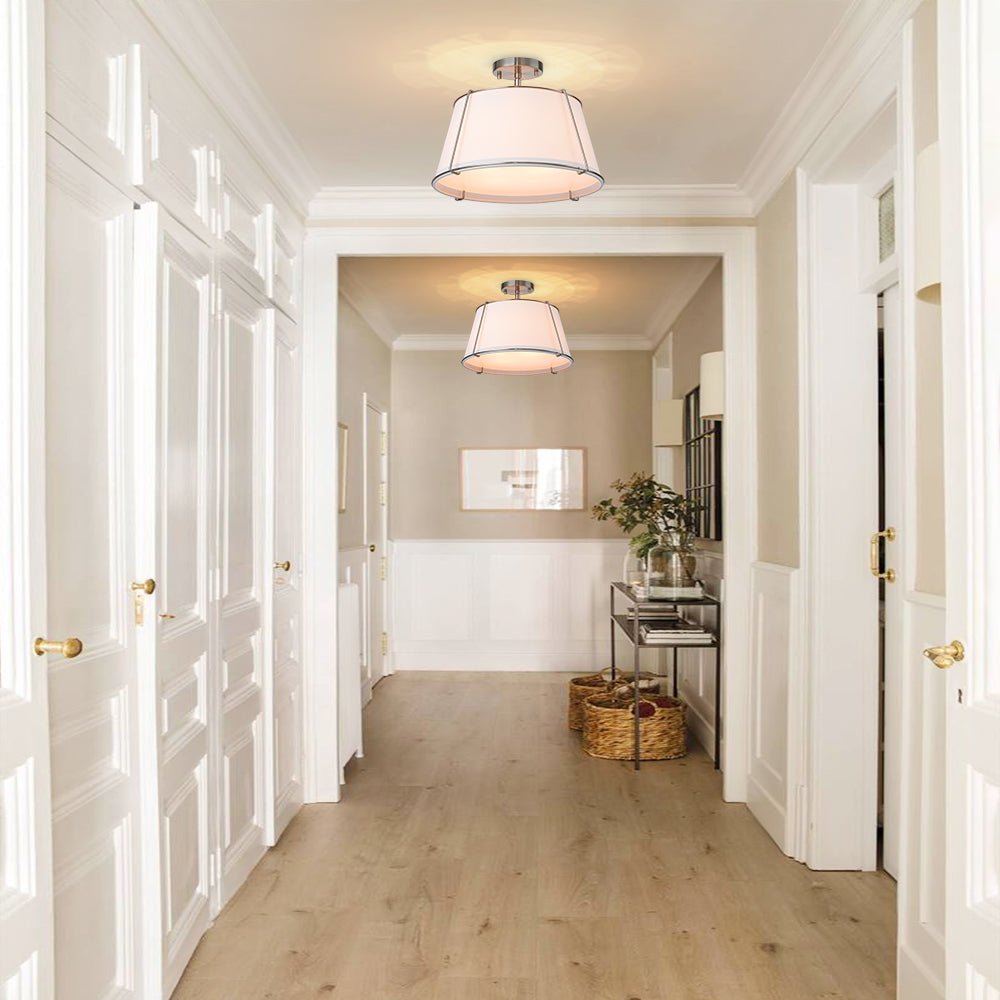 Hallway with white walls, wooden floor, and ceiling lights.
