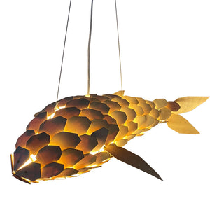 Fish-shaped pendant light with a warm glow on a white background