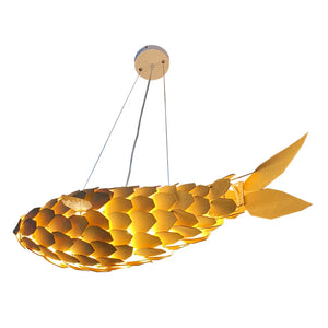 Fish-shaped pendant light with gold scales on a white background